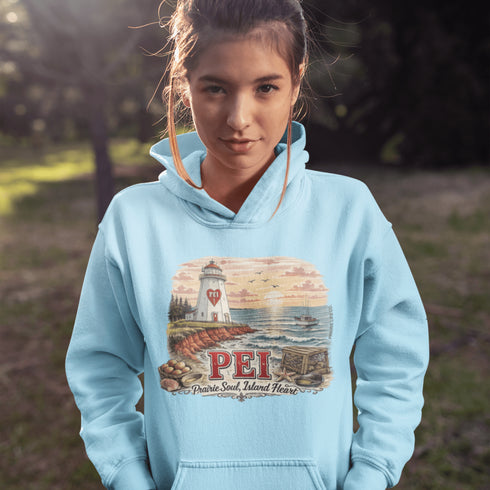 Person wearing a light blue hoodie with a lighthouse design and 'PEI' text outdoors.