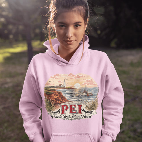 Person wearing a pink hoodie with a scenic design and 'PEI' text outdoors.