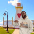 Person wearing a hoodie with PEI design in front of a lighthouse.