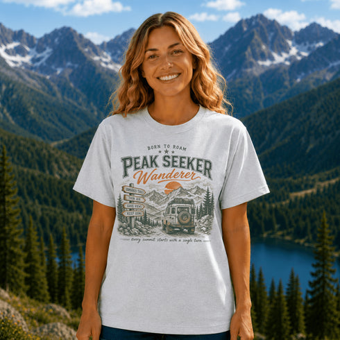 Woman wearing a 'Peak Seeker Wanderer' t-shirt with a mountainous landscape in the background