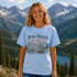 Woman wearing a 'Peak Seeker Wanderer' t-shirt with a mountainous landscape in the background