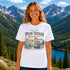 Woman wearing a 'Peak Seeker Wanderer' t-shirt with a mountainous landscape in the background