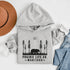 Our Prairie Life Co. Signature Hoodie captures the essence of the wilderness, featuring a striking design of a bear roaming among tall trees.