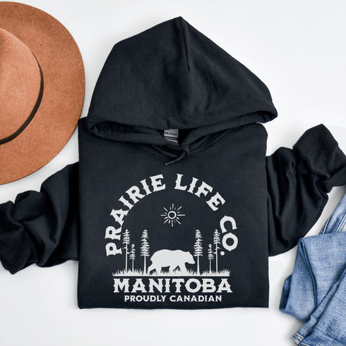 Featuring a bold graphic of a majestic bear surrounded by trees, this hoodie is perfect for those who love exploring nature or simply want to carry a bit of wilderness with them wherever they go.