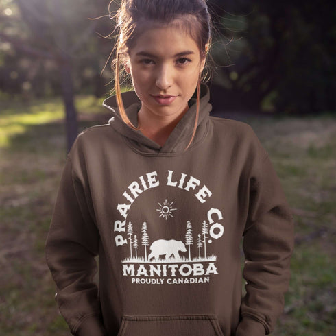 Featuring a bold graphic of a majestic bear surrounded by trees, this hoodie is perfect for those who love exploring nature or simply want to carry a bit of wilderness with them wherever they go.