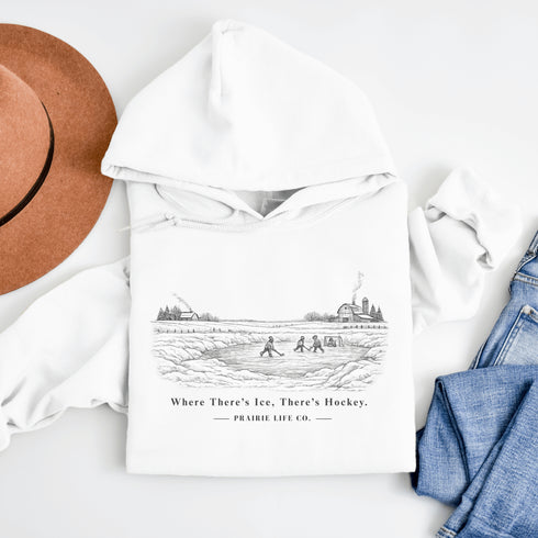 Celebrate the magic of winter with our Winter Pond Hockey Hoodie. Featuring kids playing hockey on a frozen pond, a rustic barn, snowy trees – perfect for hockey moms, fans, and winter lovers.