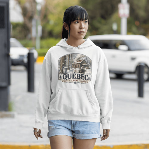 Person wearing a hoodie with 'Quebec' design outdoors.