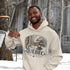 Man wearing a hoodie with a Québec design in a snowy outdoor setting