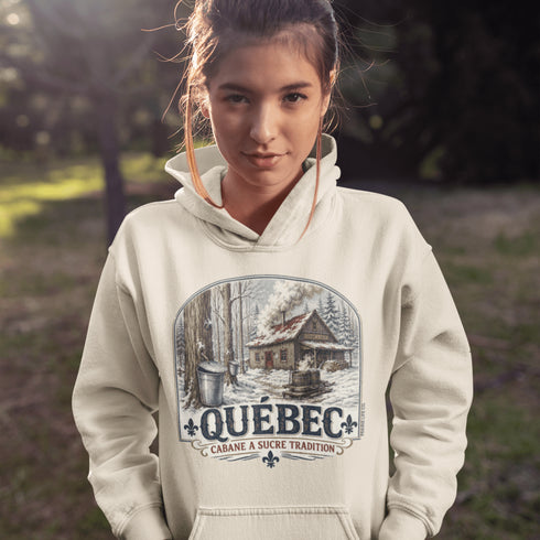 Person wearing a hoodie with a Québec-themed design outdoors.