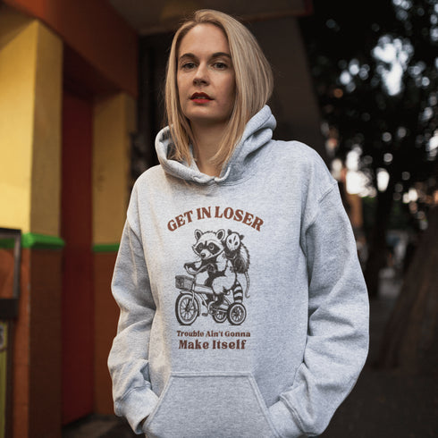 Fuel your wild side with our bold and hilarious hoodie featuring a mischievous raccoon and possum duo cruising on a bike.