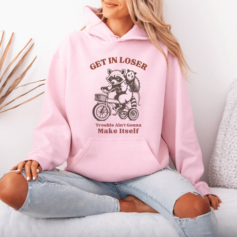 Fuel your wild side with our bold and hilarious hoodie featuring a mischievous raccoon and possum duo cruising on a bike.
