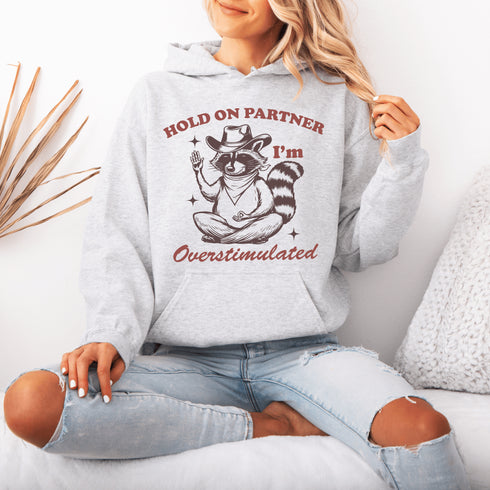 This hoodie combines the wisdom of the Wild West with the zen of overstimulation recovery. Featuring a raccoon—rocking a cowboy hat, and meditating.