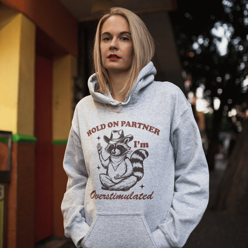 This hoodie combines the wisdom of the Wild West with the zen of overstimulation recovery. Featuring a raccoon—rocking a cowboy hat, and meditating.
