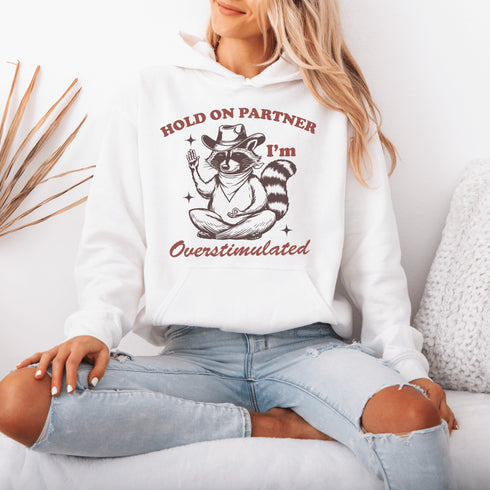 This hoodie combines the wisdom of the Wild West with the zen of overstimulation recovery. Featuring a raccoon—rocking a cowboy hat, and meditating.