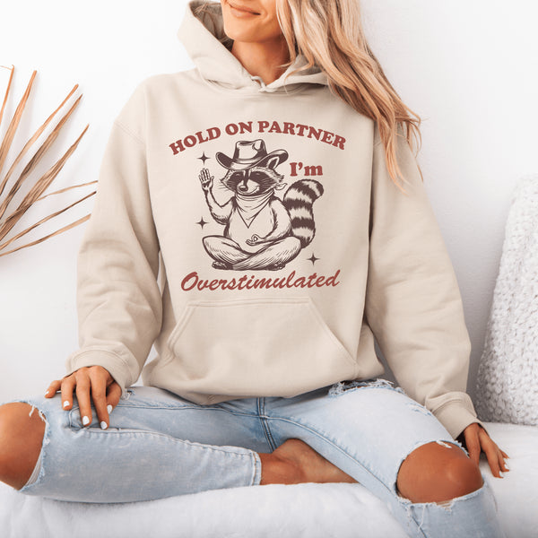 This hoodie combines the wisdom of the Wild West with the zen of overstimulation recovery. Featuring a raccoon—rocking a cowboy hat, and meditating.