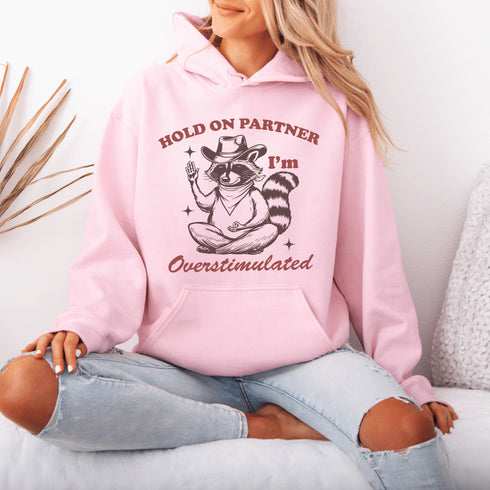 This hoodie combines the wisdom of the Wild West with the zen of overstimulation recovery. Featuring a raccoon—rocking a cowboy hat, and meditating.