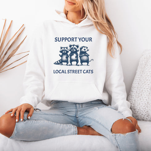 Nothing says “community support” like two raccoons and a possum banding together for the greater good (or maybe just snacks).