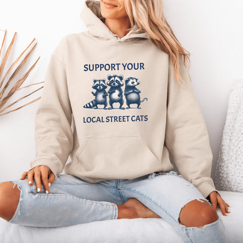 Nothing says “community support” like two raccoons and a possum banding together for the greater good (or maybe just snacks).