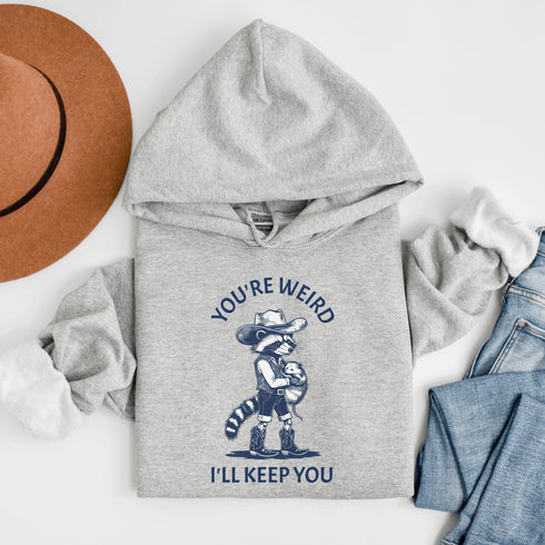 A love story for the ages: a raccoon dressed as a cowboy cradling its possum partner in crime, because nothing says "friendship" like embracing each other's weirdness.