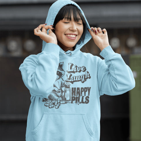 Introducing the "Live, Laugh, Happy Pills" Hoodie—because who better to take life advice from than a raccoon with a bottle of questionable pharmaceuticals? 🦝💊