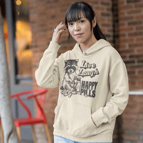 Introducing the "Live, Laugh, Happy Pills" Hoodie—because who better to take life advice from than a raccoon with a bottle of questionable pharmaceuticals? 🦝💊