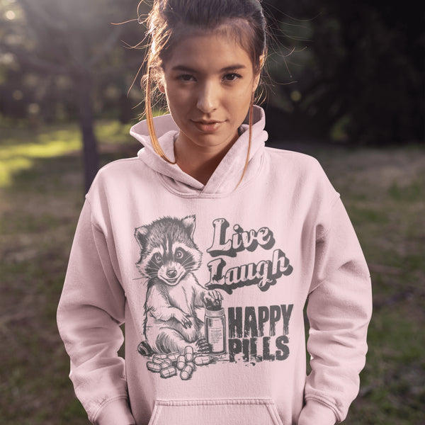 Introducing the "Live, Laugh, Happy Pills" Hoodie—because who better to take life advice from than a raccoon with a bottle of questionable pharmaceuticals? 🦝💊