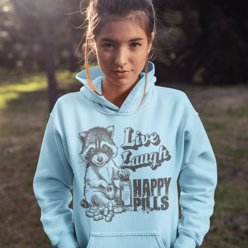 Introducing the "Live, Laugh, Happy Pills" Hoodie—because who better to take life advice from than a raccoon with a bottle of questionable pharmaceuticals? 🦝💊