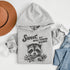 Introducing the "Sweet, But Will Throw Hands" Hoodie—perfect for those who are 90% cute and 10% ready to fight (especially over snacks). Featuring a cartoon raccoon that’s equal parts charming and feisty, this hoodie is a gentle reminder that while you're sweet, you’re not to be messed with! 🦝👊