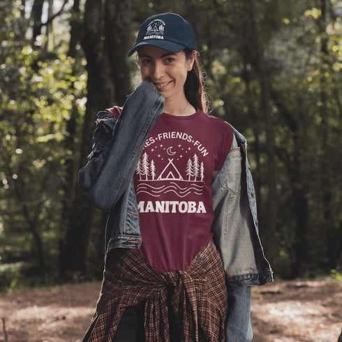Introducing our exclusive camping t-shirt featuring a camping scene and the catchy slogan "Manitoba - Fires, Friends, Fun."