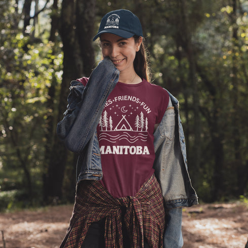 Introducing our exclusive camping t-shirt featuring a camping scene and the catchy slogan "Manitoba - Fires, Friends, Fun."