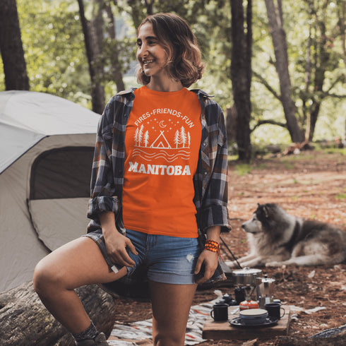 Introducing our exclusive camping t-shirt featuring a camping scene and the catchy slogan "Manitoba - Fires, Friends, Fun."