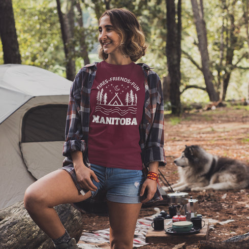 Introducing our exclusive camping t-shirt featuring a camping scene and the catchy slogan "Manitoba - Fires, Friends, Fun."