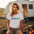 This unique tee features a captivating camping scene intricately etched inside the word "Camping," creating a stunning visual that captures the essence of outdoor adventure.