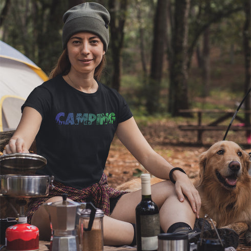 This unique tee features a captivating camping scene intricately etched inside the word "Camping," creating a stunning visual that captures the essence of outdoor adventure.