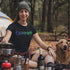 This unique tee features a captivating camping scene intricately etched inside the word "Camping," creating a stunning visual that captures the essence of outdoor adventure.
