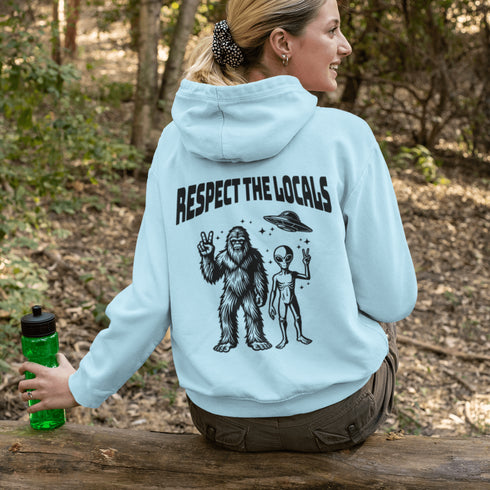 The Respect the Locals Hoodie features this dynamic duo (Big Foot & Alien) striking a pose like they’re on the cover of Paranormal Weekly