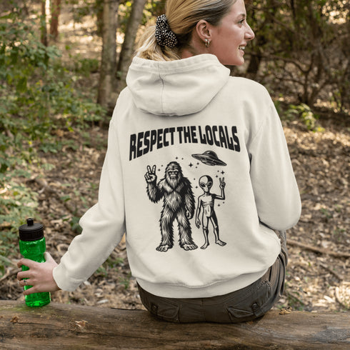 The Respect the Locals Hoodie features this dynamic duo (Big Foot & Alien) striking a pose like they’re on the cover of Paranormal Weekly