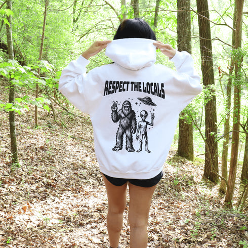 The Respect the Locals Hoodie features this dynamic duo (Big Foot & Alien) striking a pose like they’re on the cover of Paranormal Weekly