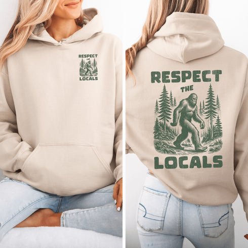 Our Respect the Locals Hoodie features the legend himself—Bigfoot—just casually strolling through the forest like it’s his backyard (because it is).