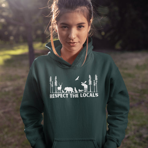 Step into the heart of the forest with our “Respect The Locals” hoodie, where artfully illustrated woodland animals roam under a canopy of trees.