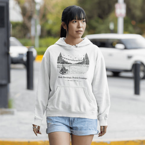 Cozy outdoor hockey hoodie featuring a glowing rink graphic and prairie winter vibe. Perfect for skating, cabin nights, and cold-weather comfort.