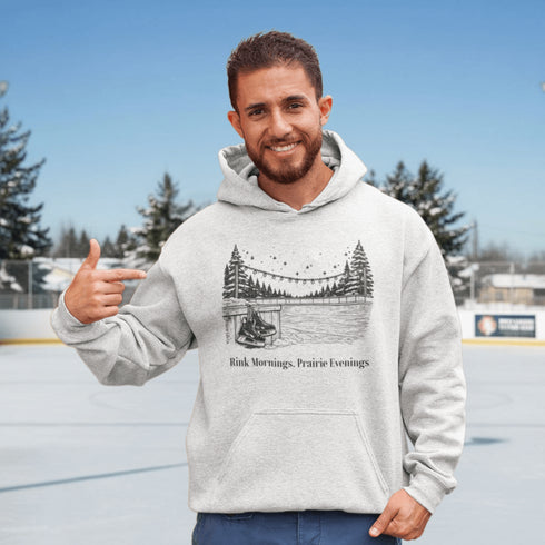 Cozy outdoor hockey hoodie featuring a glowing rink graphic and prairie winter vibe. Perfect for skating, cabin nights, and cold-weather comfort.