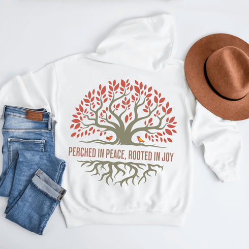 This design features a beautifully crafted tree with flowing roots, symbolizing strength and connection, paired with the uplifting saying, "Perched in peace, rooted in joy."