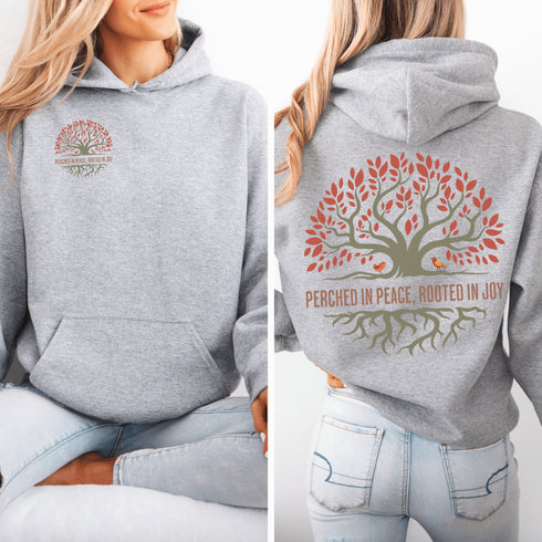 This design features a beautifully crafted tree with flowing roots, symbolizing strength and connection, paired with the uplifting saying, "Perched in peace, rooted in joy."
