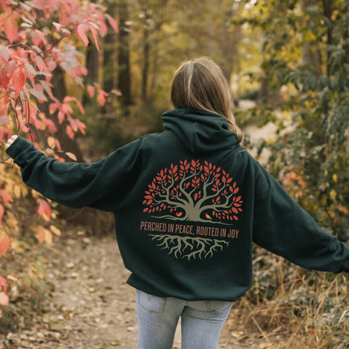This design features a beautifully crafted tree with flowing roots, symbolizing strength and connection, paired with the uplifting saying, "Perched in peace, rooted in joy."