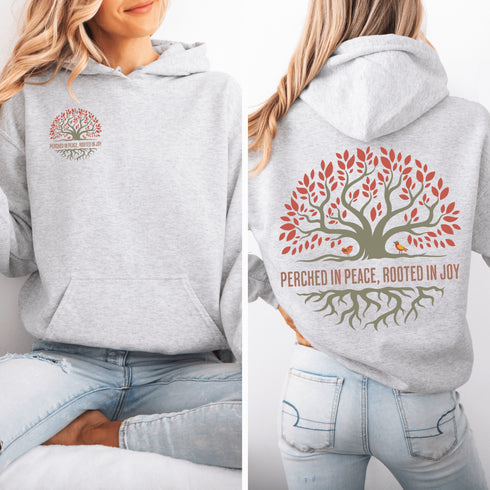 This design features a beautifully crafted tree with flowing roots, symbolizing strength and connection, paired with the uplifting saying, "Perched in peace, rooted in joy."