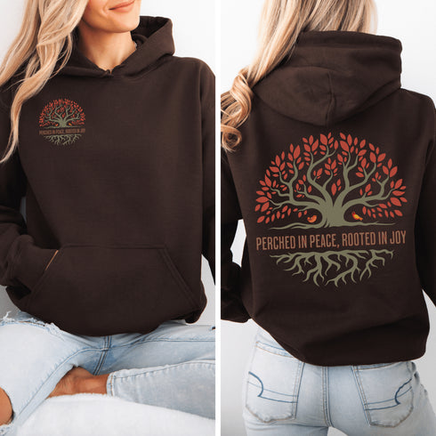 This design features a beautifully crafted tree with flowing roots, symbolizing strength and connection, paired with the uplifting saying, "Perched in peace, rooted in joy."
