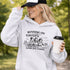 Soccer mom hoodie with “Running on Coffee and Game Day Chaos” design featuring moms cheering on the sidelines with kids playing soccer in the background