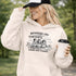 Soccer mom hoodie with “Running on Coffee and Game Day Chaos” design featuring moms cheering on the sidelines with kids playing soccer in the background