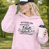 Soccer mom hoodie with “Running on Coffee and Game Day Chaos” design featuring moms cheering on the sidelines with kids playing soccer in the background